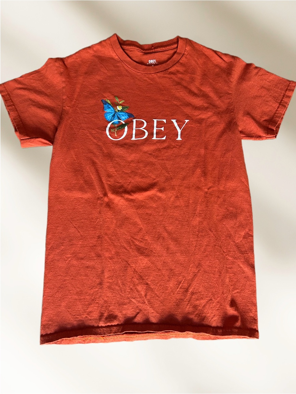 Obey Orange Tee with White Logo and Blue Butterfly